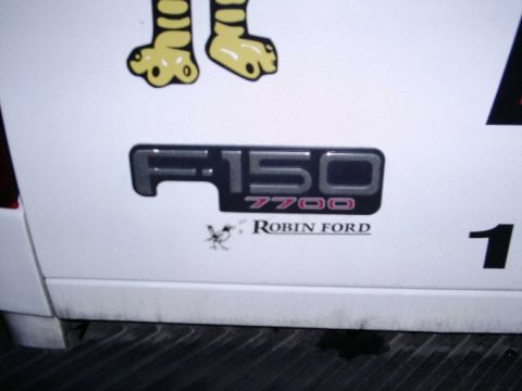 1997 Ford F-150 - Close-up of a Ford F-150 7700 badge, indicating a specific trim or package.