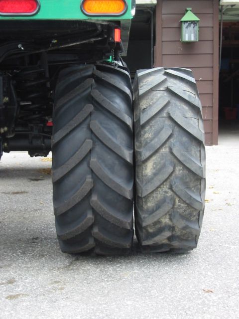 1991 Ford Bronco - Comparison of a new tractor tire next to a used one, showing tread wear.