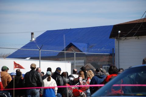 1996 Ford Bronco - A crowd of people are gathered, with a red motorcycle visible in the foreground.