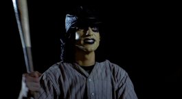 1973 Ford Ranchero - A person dressed as a baseball player, with face paint, stands ready with a bat.
