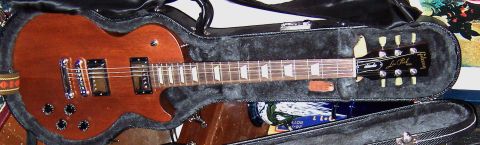 1978 Ford Bronco - A Gibson Les Paul electric guitar rests inside its protective case.