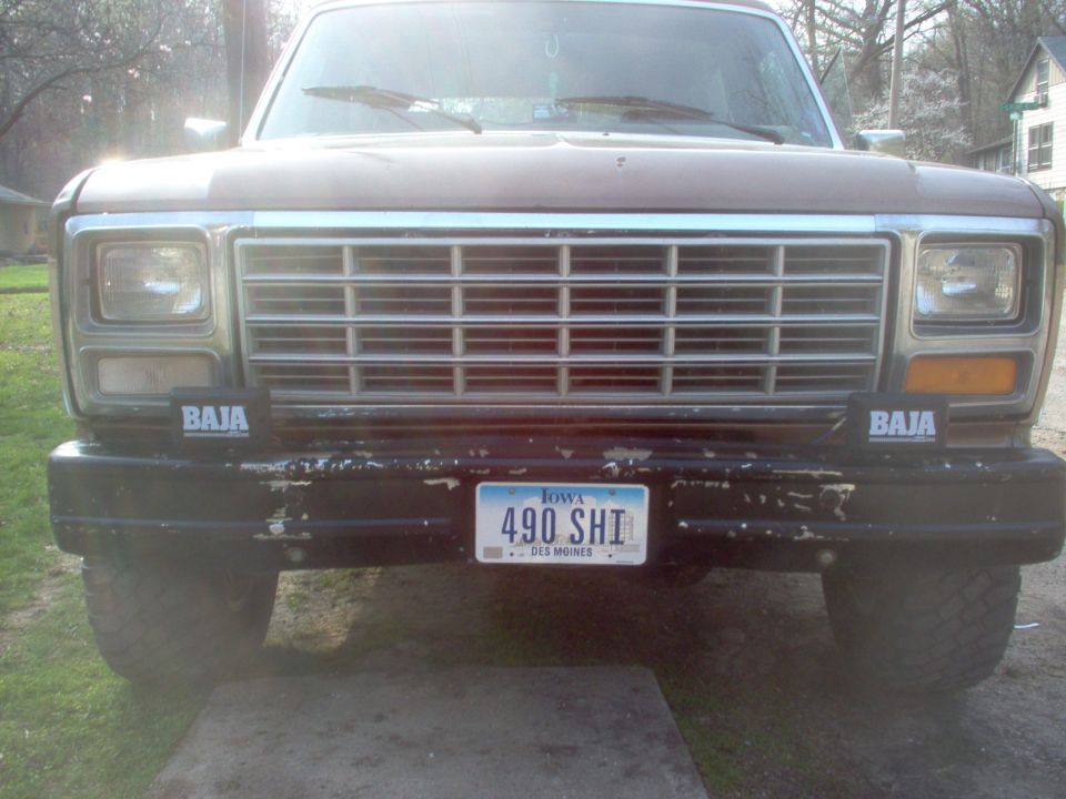 Brown 1980s Ford Bronco front view with chrome grille and Baja lights