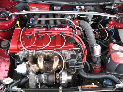 2006 Mazda 6 - Close-up of a modified Mazda engine bay, a turbocharger and custom fuel lines.