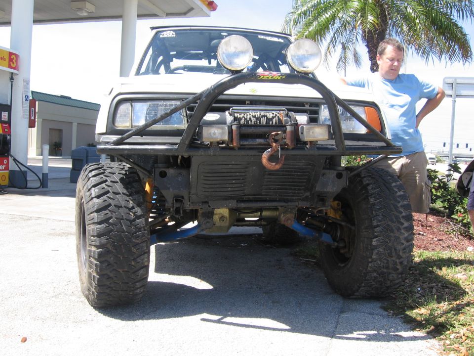 White off-road SUV front view with bull bar and winch