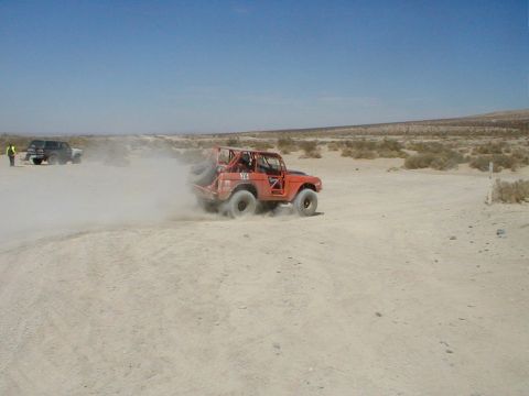 1996 Ford Bronco - Off-road racing in the desert with a 1996 Ford Bronco and another vehicle.