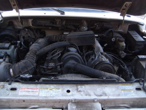 1997 Ford Ranger - Engine bay of a 1997 Ford Ranger, focusing on the coolant system and surrounding components.