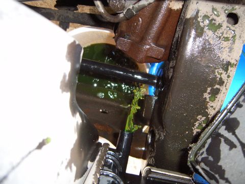 1997 Ford Ranger - Green coolant is visibly leaking from a hose in the engine bay.