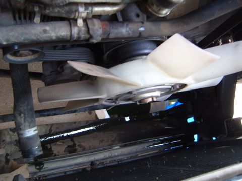 1997 Ford Ranger - Engine fan and belts are visible, with a coolant leak evident below.