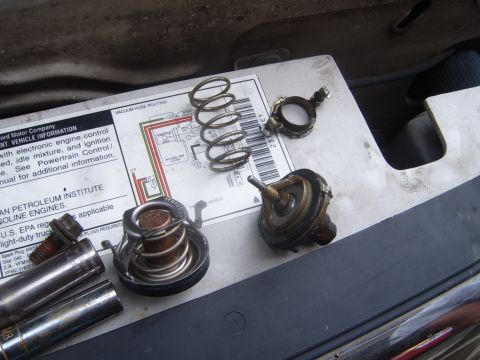 1997 Ford Ranger - Disassembled engine parts, including a thermostat and springs, are laid out on a diagram.