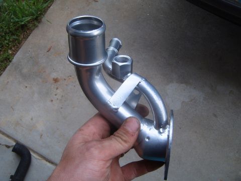 1997 Ford Ranger - A metal coolant pipe, likely for a vehicle's cooling system, is held in a hand.