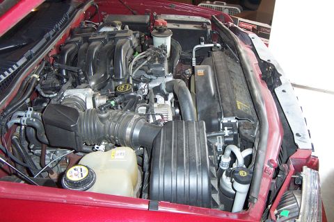 2005 Ford Explorer - Engine bay of a 2005 Ford Explorer, the V8 engine and red exterior paint.