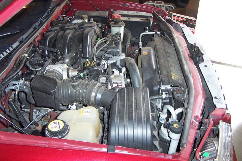 2005 Ford Explorer engine bay with V8 engine and red exterior