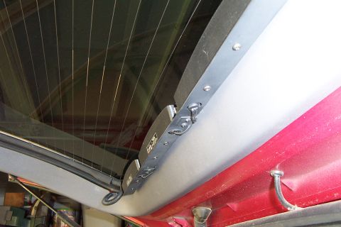 2005 Ford Explorer - The interior rear window latch mechanism is visible, attached to the vehicle's headliner.