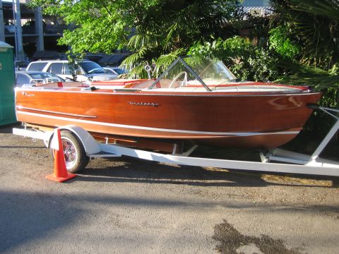 1996 Ford Bronco - Wooden boat on trailer with orange traffic cone nearby.