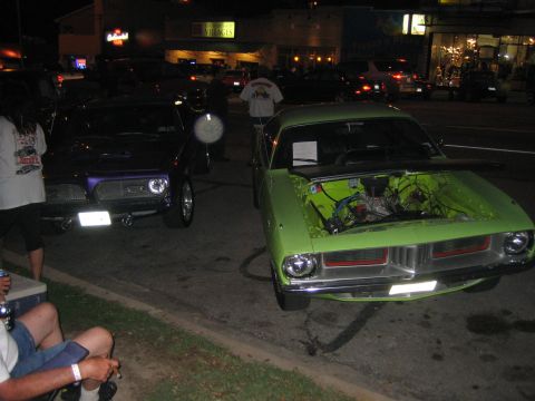 1996 Ford Bronco - A lime green muscle car is parked with its hood open, revealing the engine compartment.
