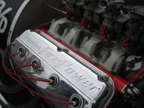 1996 Ford Bronco - Close-up of a chrome valve cover reading 'Chrysler FirePower' with red spark plug wires connected.