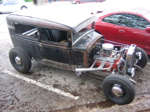 1996 Ford Bronco - Custom hot rod sedan with a visible V8 engine and modified exhaust system.