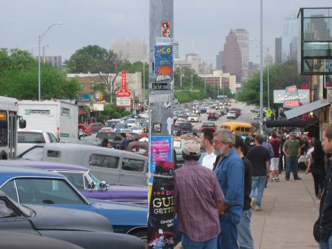 1996 Ford Bronco - A busy street scene with a traffic jam and people gathered on the sidewalk.