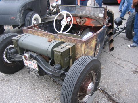 1996 Ford Bronco - Rat rod with custom fuel tank and ammo can storage, another car in background.
