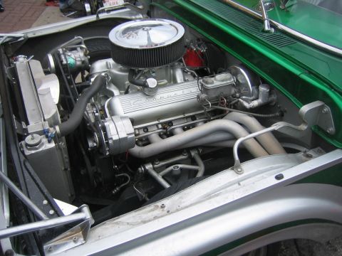 1996 Ford Bronco - The engine bay of a custom vehicle showcases a polished Chevrolet V8 engine with custom exhaust headers.