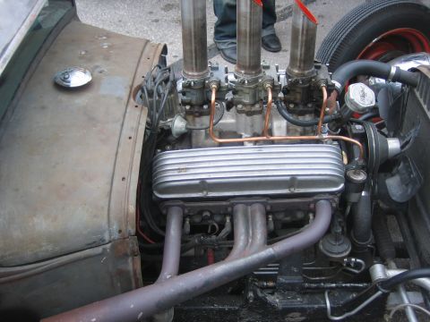 1996 Ford Bronco - Close-up of a V8 engine with multiple carburetors and exhaust pipes, likely from a custom build.