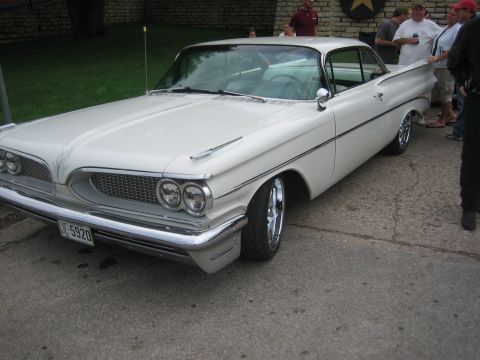 1996 Ford Bronco - This 1959 Pontiac Bonneville coupe features distinctive fins and a prominent chrome grille, seen here from a 3q-front perspective.