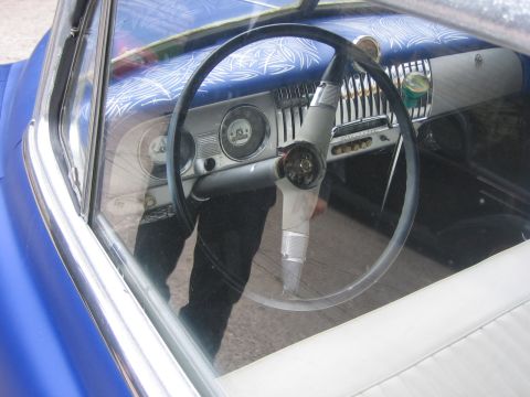 1996 Ford Bronco - Interior view of a blue car, showing the steering wheel, dashboard, and seats.
