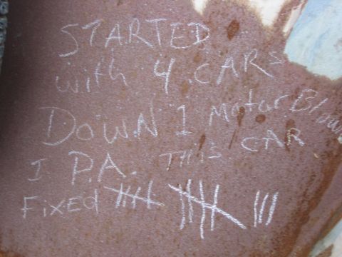 1996 Ford Bronco - Chalked tally marks and text on a rusty surface detail a history of car maintenance or vehicle maintenance.