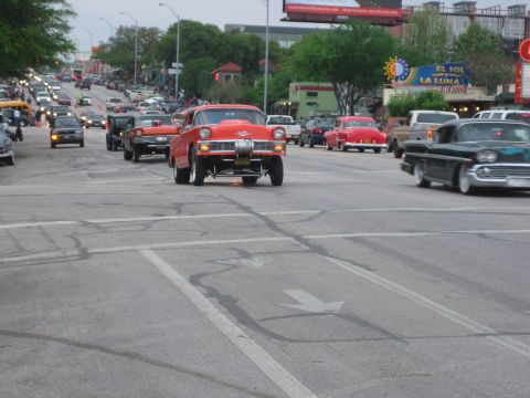 1996 Ford Bronco - Custom hot rod leads a procession of classic cars down a city street.