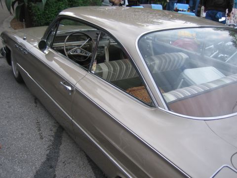 1996 Ford Bronco - The interior of a vintage car is visible, striped upholstery and a wicker basket.