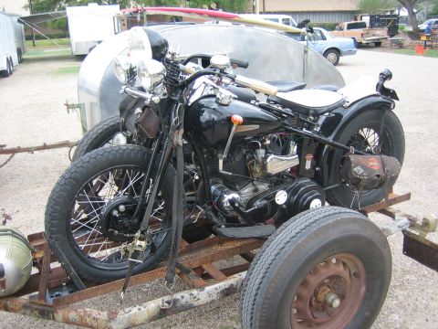 1996 Ford Bronco - Vintage Harley-Davidson motorcycle loaded onto a trailer, with a surfboard visible on another trailer.