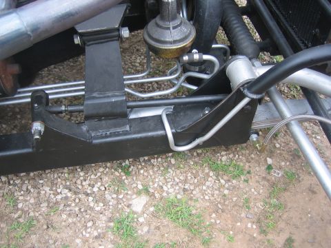 1996 Ford Bronco - Detail shot of vehicle chassis components, including brake lines and suspension hardware.