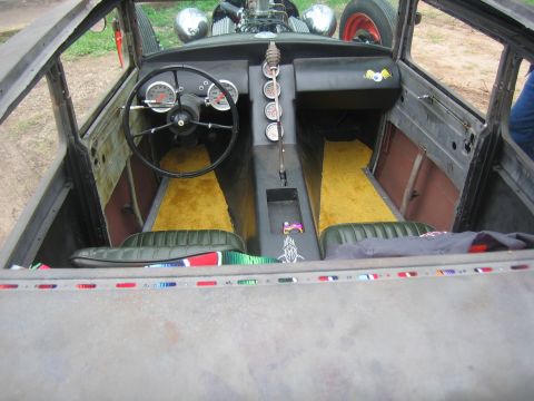 1996 Ford Bronco - The interior of a custom hot rod features a unique dashboard with multiple gauges and a grenade-style shifter.
