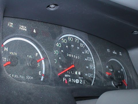 2000 Ford Crown Victoria - Close-up of a vehicle's interior dashboard gauges, including the speedometer, fuel, volts, temperature, and oil indicators.