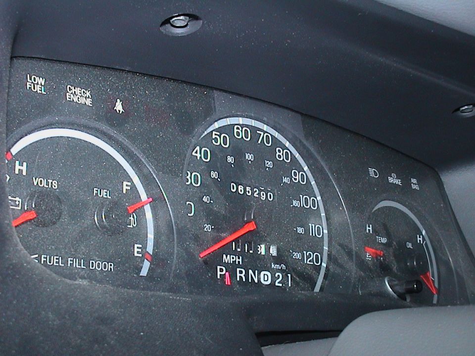 Dusty Ford gauge cluster face, 120 mph speedometer and 65,290-mile odometer
