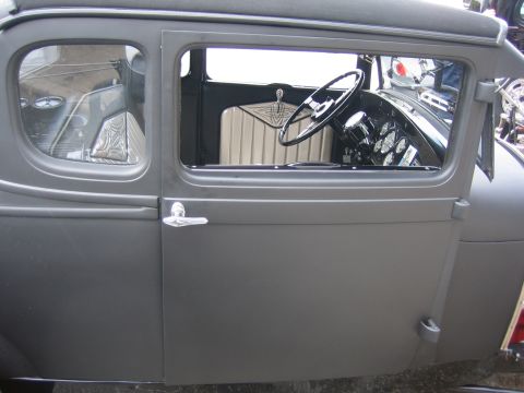 1996 Ford Bronco - The interior of a custom coupe features a classic steering wheel and a dashboard filled with gauges.