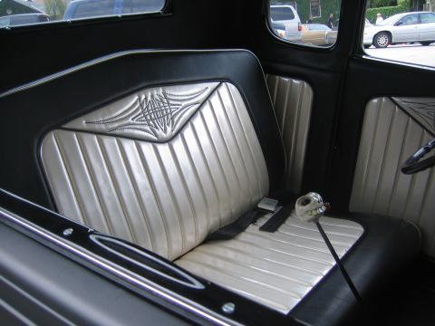 1996 Ford Bronco - The interior features custom fluted silver seats with black accents and a unique skull-shaped gear shifter.