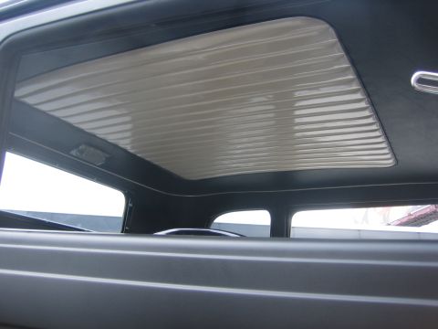 1996 Ford Bronco - The ribbed headliner and interior trim are visible in this close-up view from inside the vehicle.