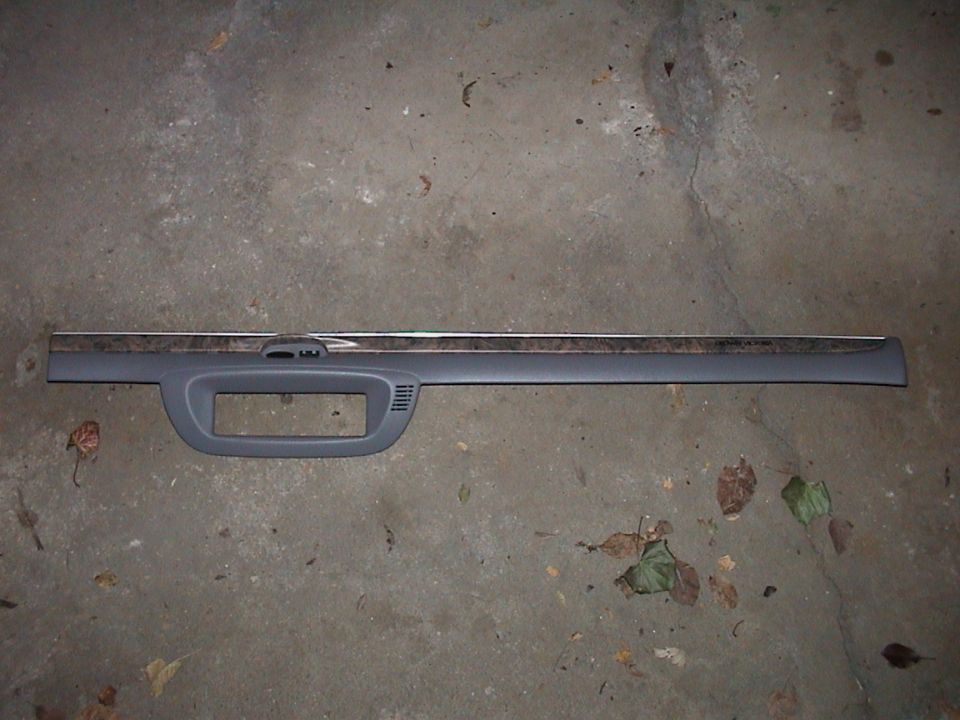 Gray dashboard trim with wood grain accent strip and rectangular cutout