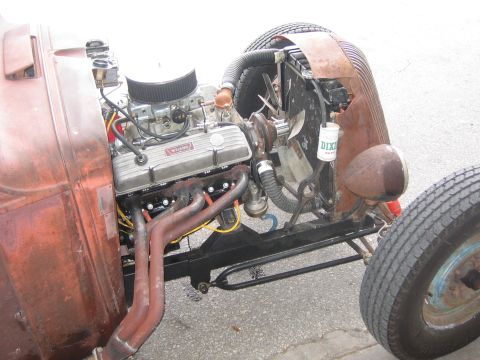 1996 Ford Bronco - Close-up view of a custom hot rod's engine bay, Weiand valve covers and exposed exhaust headers.