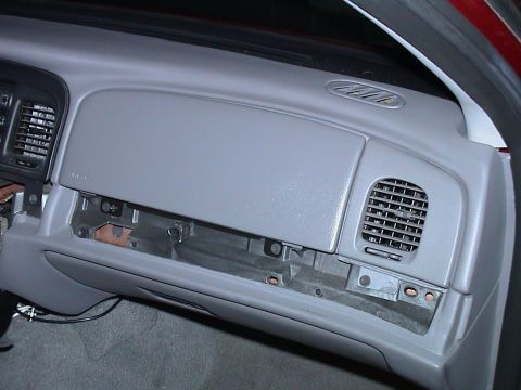 2000 Ford Crown Victoria - Interior view of a 2000 Ford Crown Victoria dashboard, with the glove compartment removed.