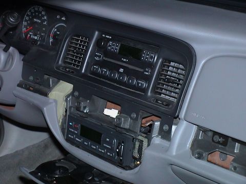 2000 Ford Crown Victoria - The dashboard of a 2000 Ford Crown Victoria is shown with the radio and surrounding trim removed.