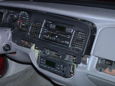 2000 Ford Crown Victoria - The dashboard of a 2000 Ford Crown Victoria is shown with the radio assembly partially removed.
