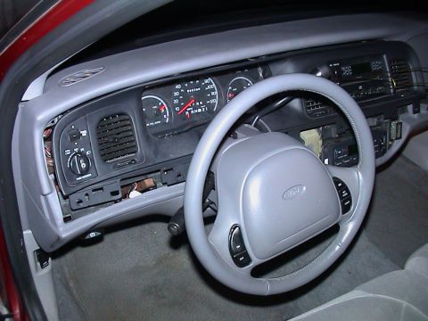 2000 Ford Crown Victoria - Interior view of a 2000 Ford Crown Victoria, focusing on the dashboard and steering wheel.