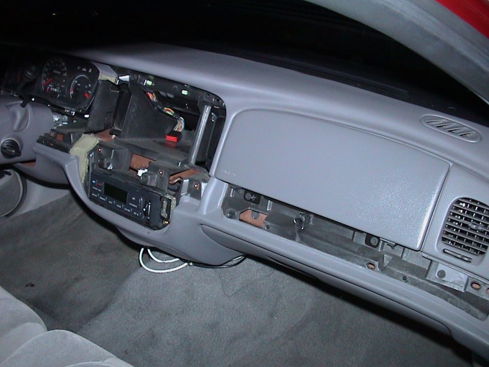 Passenger-side view of gray Ford dash with bezel removed and structure exposed