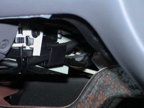 2000 Ford Crown Victoria - This photo shows a close-up view of the wiring and mechanical components located beneath the dashboard of a vehicle.