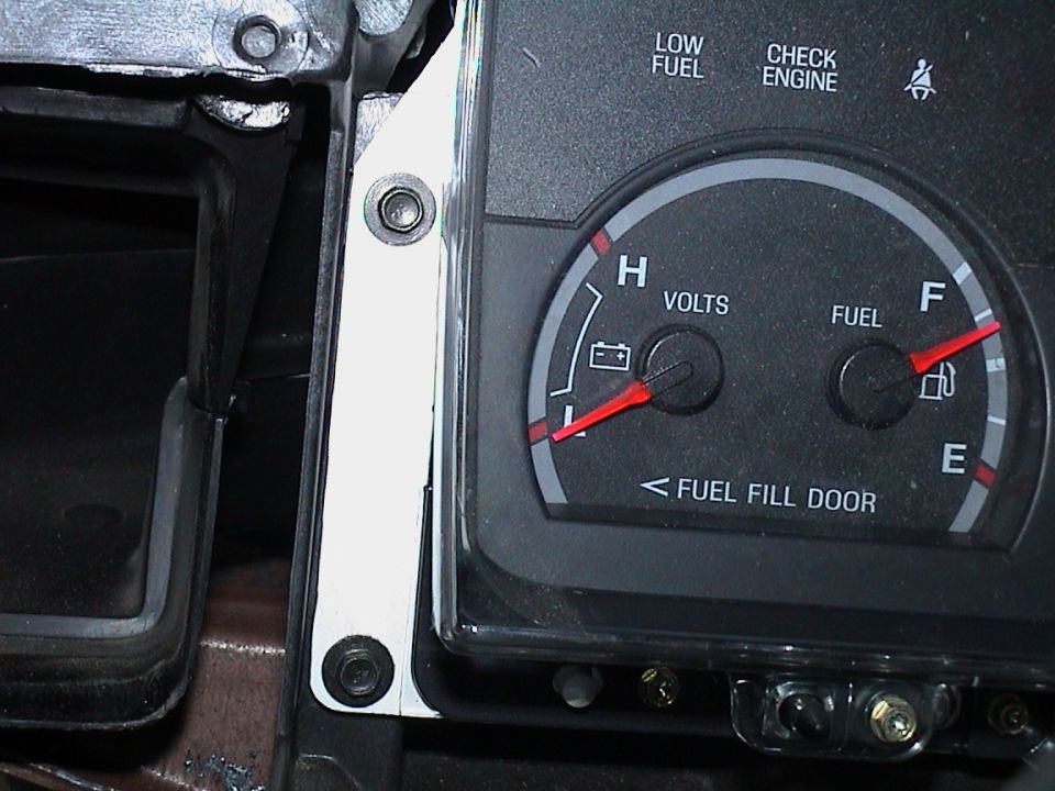 Close-up of Ford volts and fuel gauges with FUEL FILL DOOR arrow