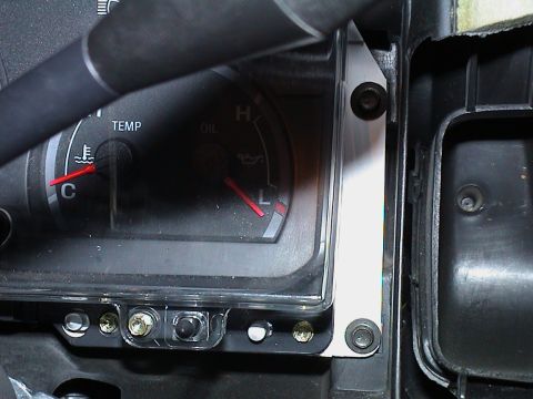2000 Ford Crown Victoria - The dashboard gauges display temperature and oil levels, with a portion of the steering wheel visible.