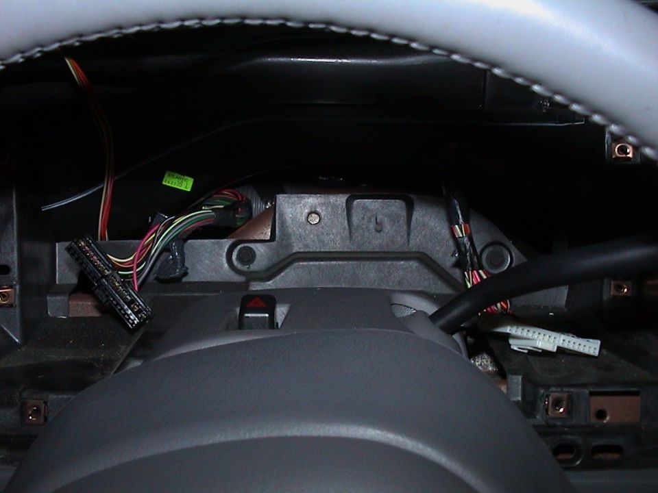 Dashboard removed showing steering column, hazard switch and loose wiring harness connectors