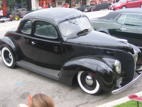 1996 Ford Bronco - Black 1939 Ford coupe hot rod with whitewall tires parked on street.